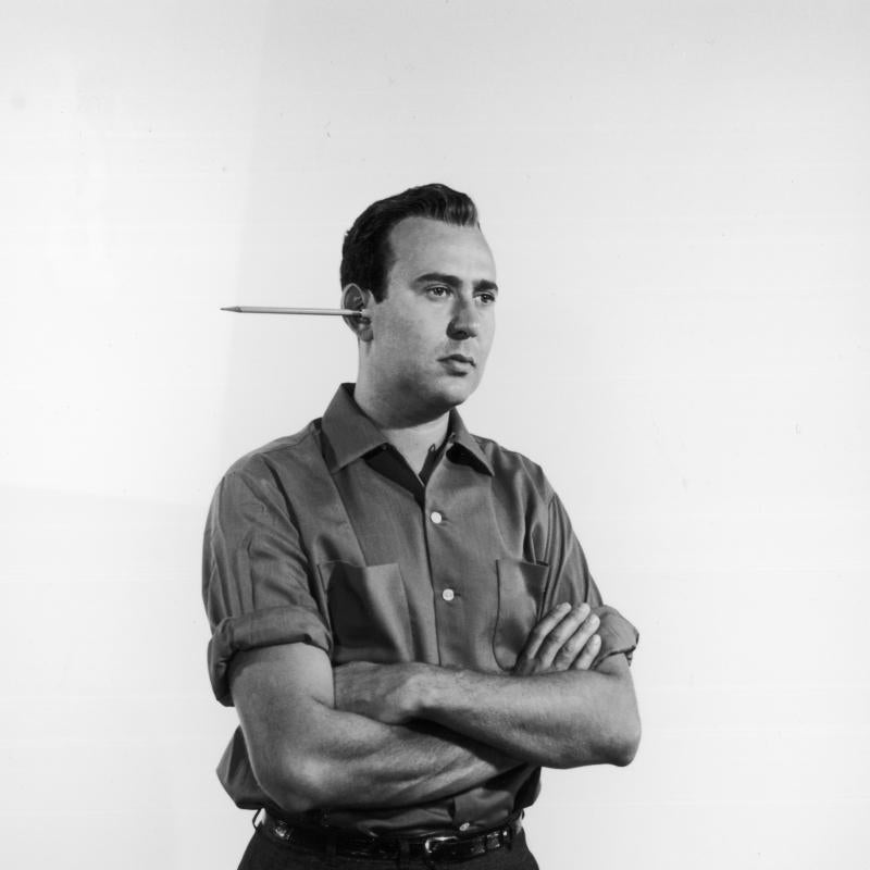 Comedy legend Carl Reiner poses with a pencil sticking out of his in 1955